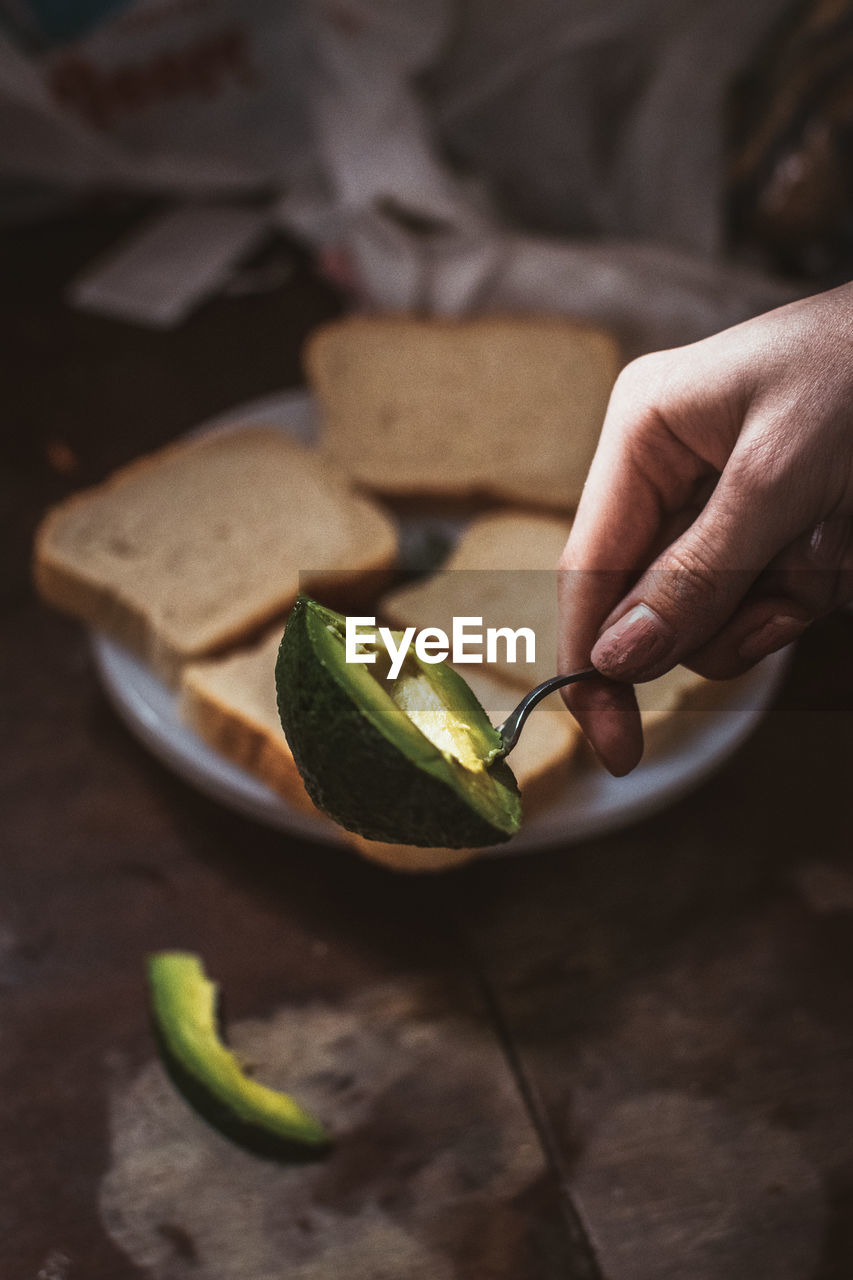 Close-up of hand holding avocado