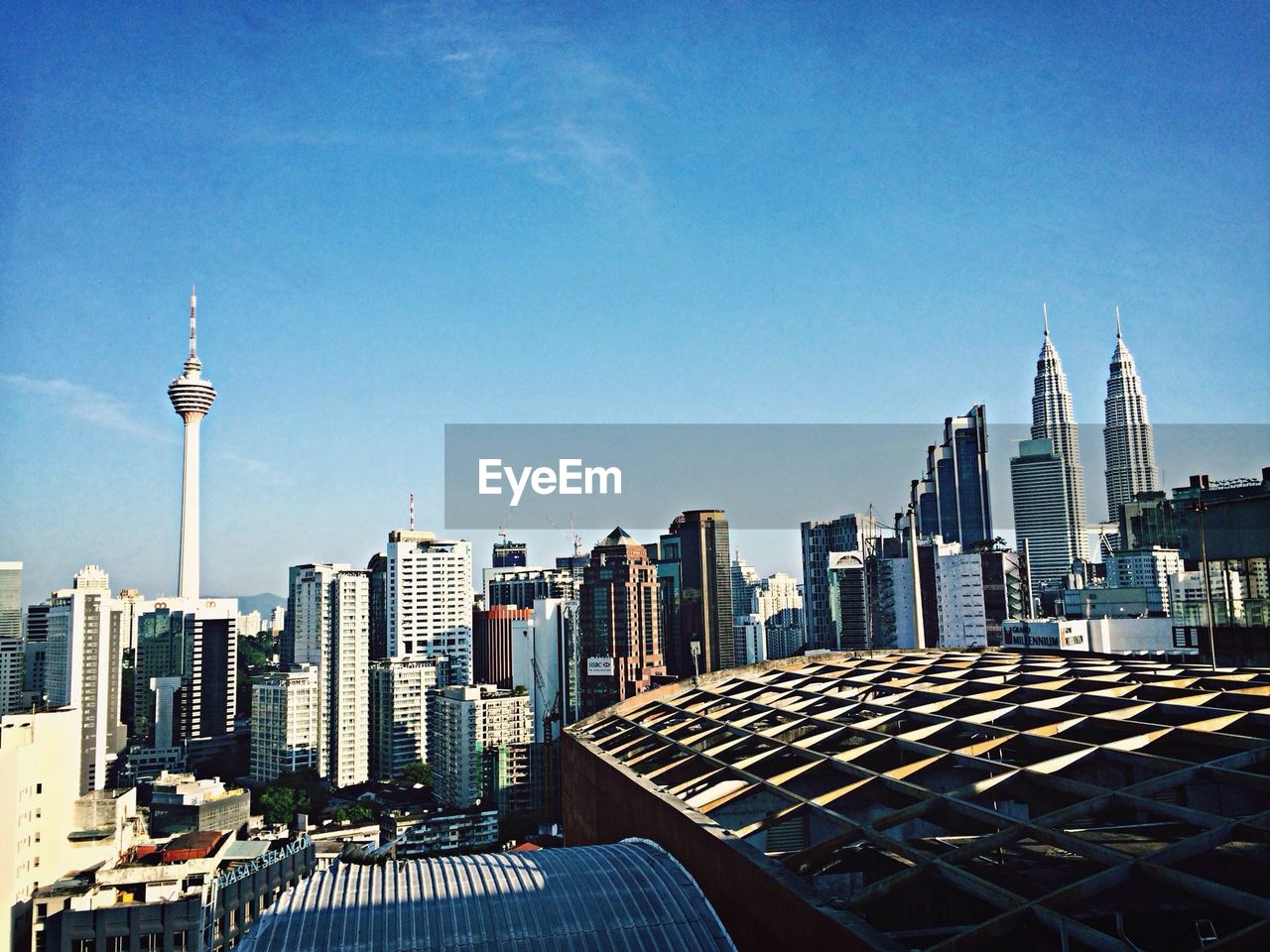 High angle view of cityscape and kuala lumpur tower against sky