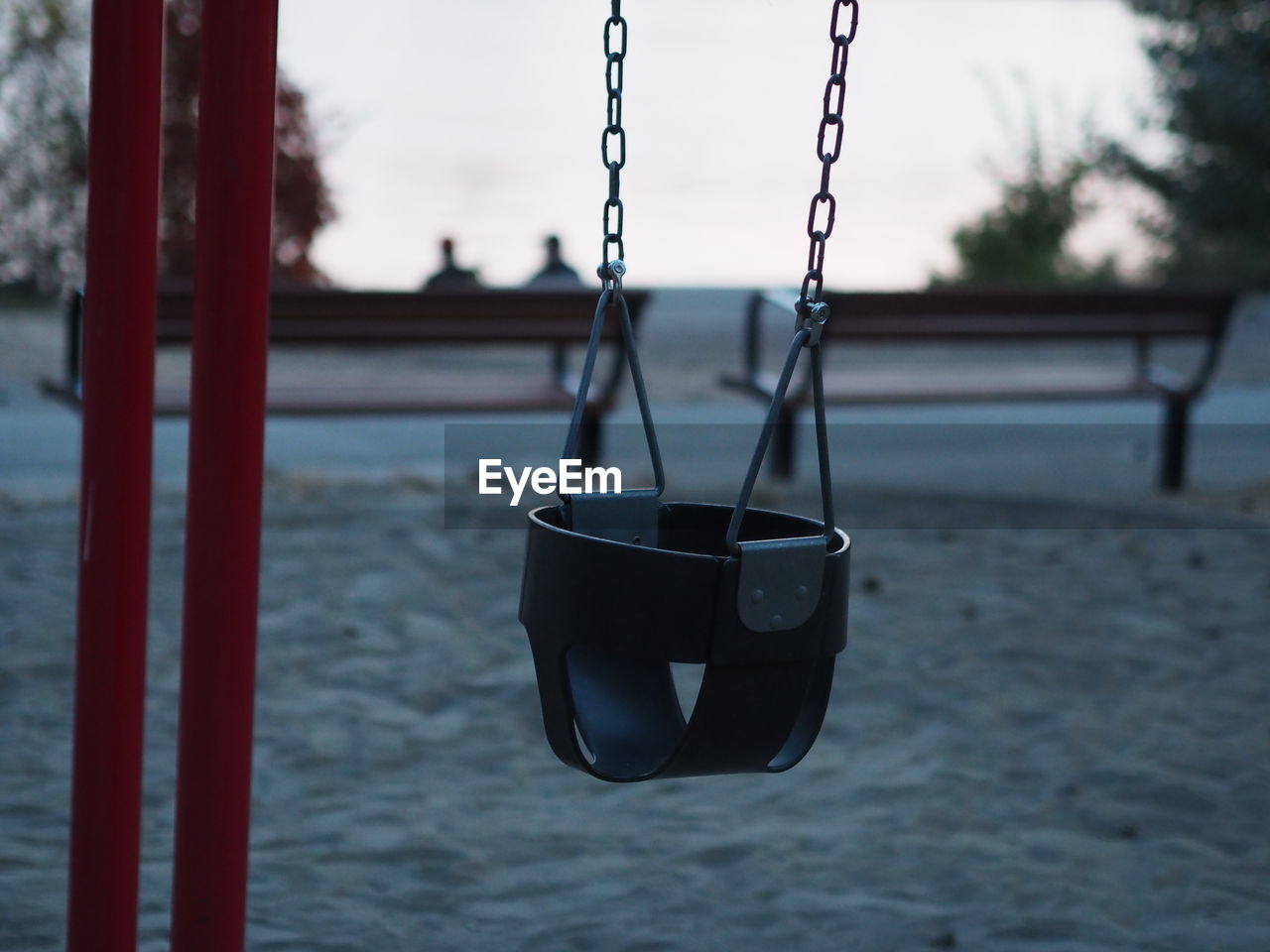 Close-up of empty swing in park during sunset