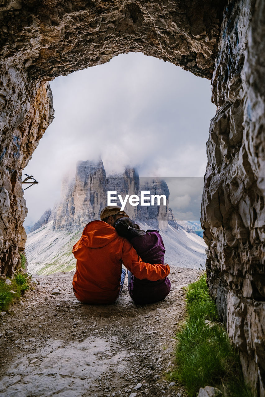 REAR VIEW OF ROCK FORMATION ON SNOW COVERED MOUNTAIN