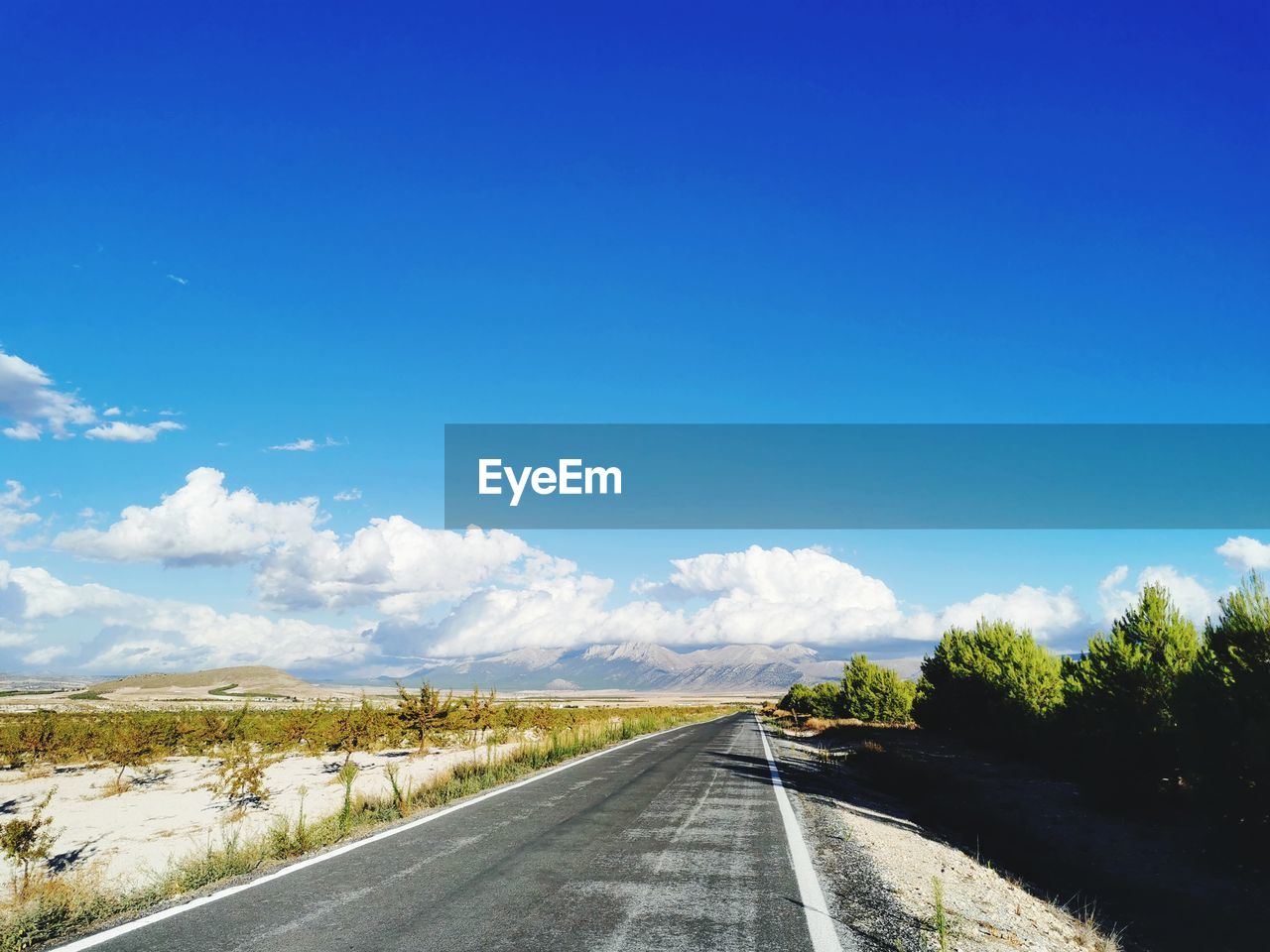 ROAD ALONG COUNTRYSIDE LANDSCAPE