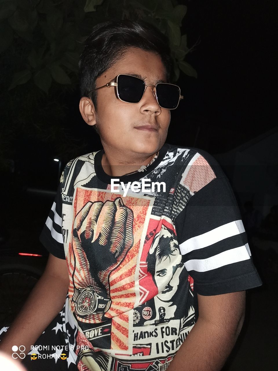 PORTRAIT OF YOUNG MAN WEARING SUNGLASSES STANDING AGAINST WALL