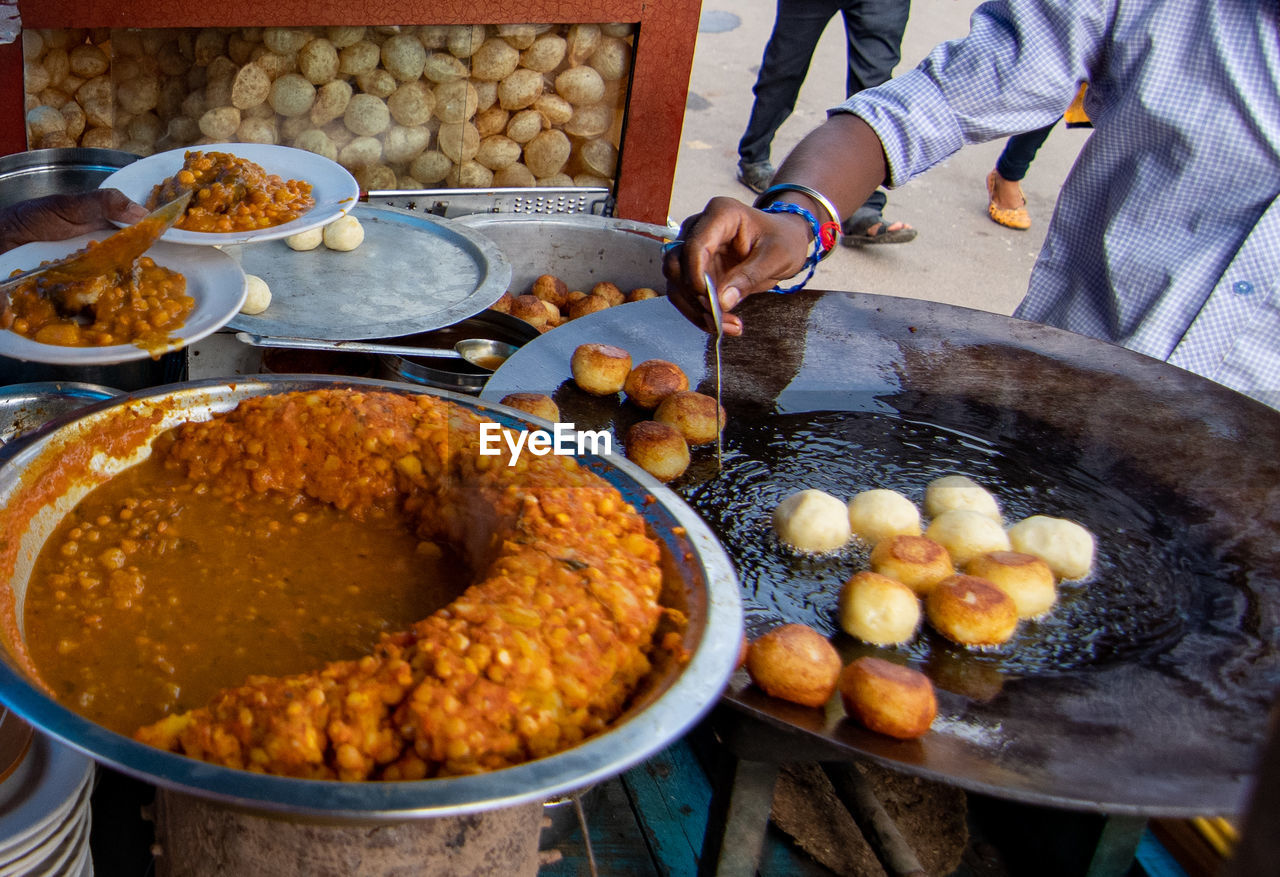 High angle view of man preparing food at market