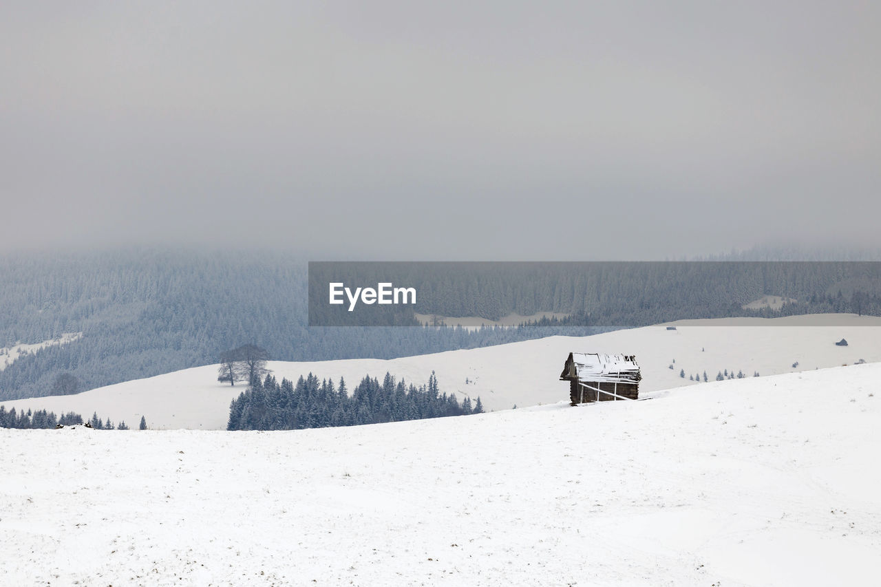 Scenic view of snow covered landscape against clear sky