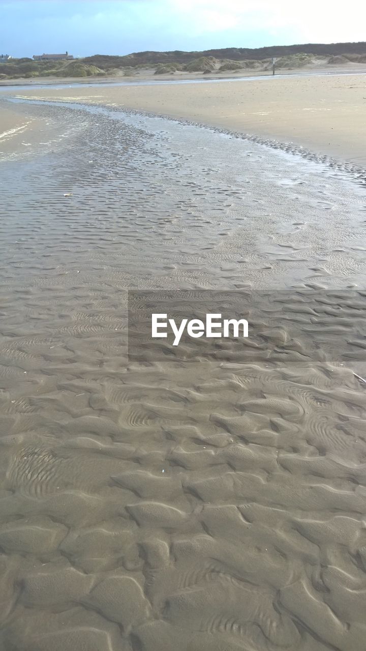 SURFACE LEVEL OF WET SAND ON BEACH