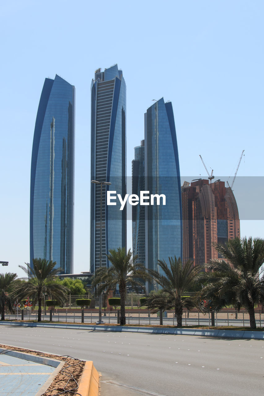 LOW ANGLE VIEW OF SKYSCRAPERS AGAINST CLEAR SKY