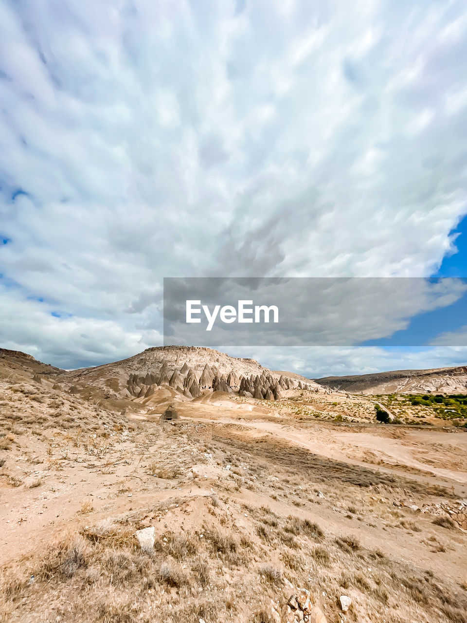 cloud, sky, landscape, environment, scenics - nature, natural environment, land, nature, sand, beauty in nature, plateau, mountain, travel, no people, horizon, travel destinations, desert, non-urban scene, sea, tranquility, outdoors, day, blue, semi-arid, soil, tourism, cloudscape, steppe, tranquil scene, rock, dramatic sky, wilderness, plant, climate, extreme terrain, sunlight