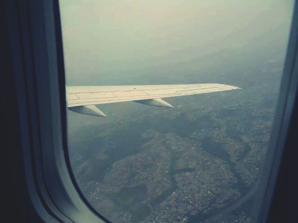 CROPPED IMAGE OF AIRPLANE WING OVER WINDOW