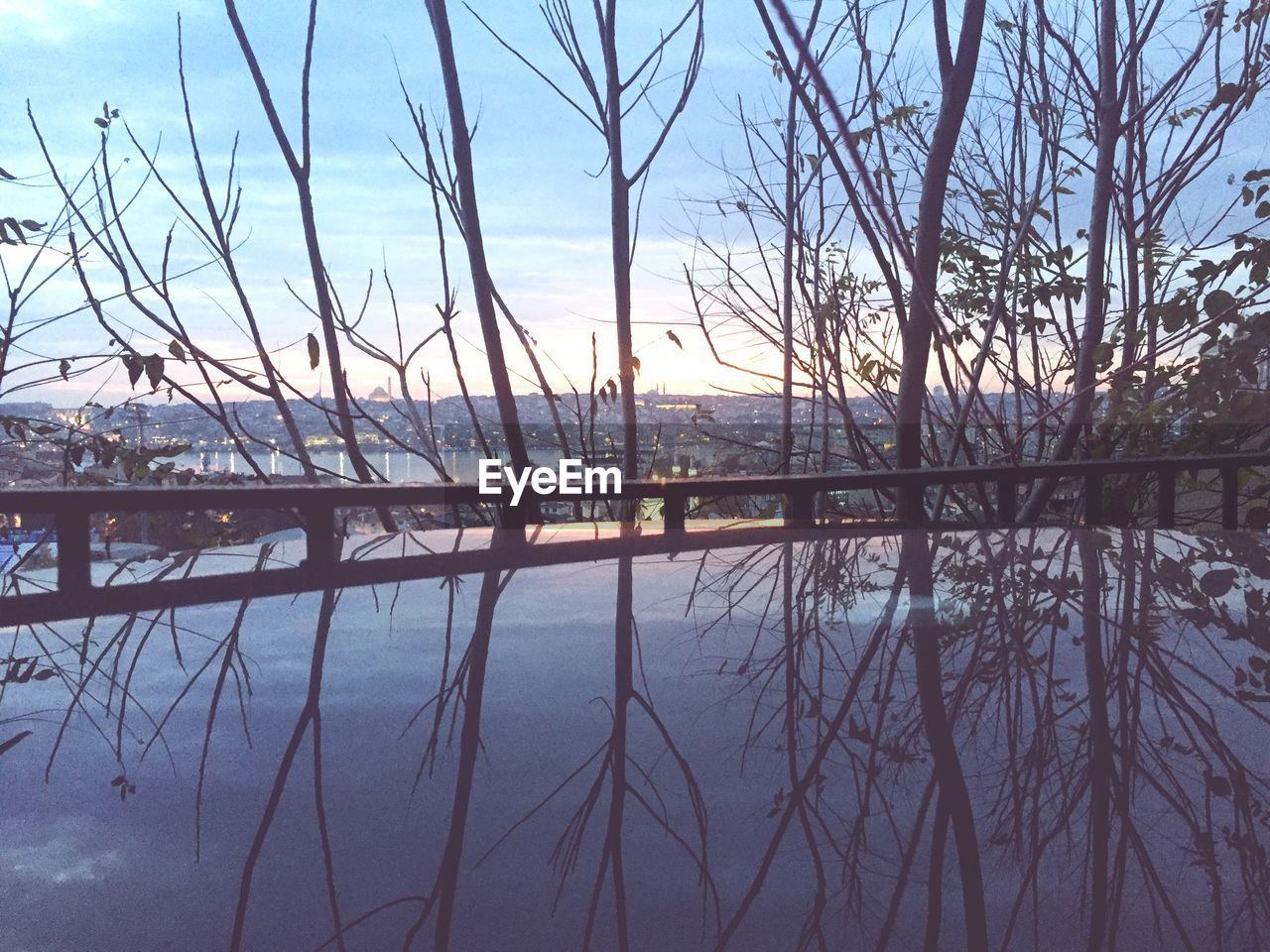 SCENIC VIEW OF LAKE AGAINST BARE TREES