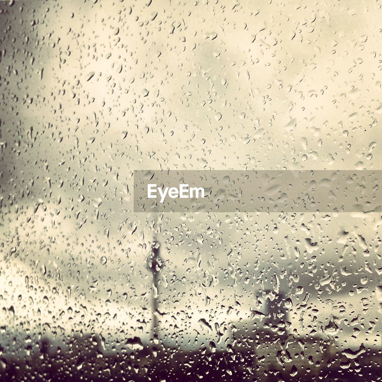 Communications tower seen through window glass