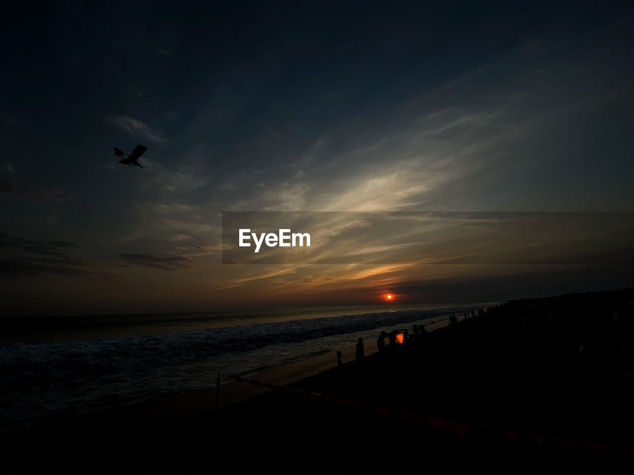 SCENIC VIEW OF SUNSET OVER BEACH
