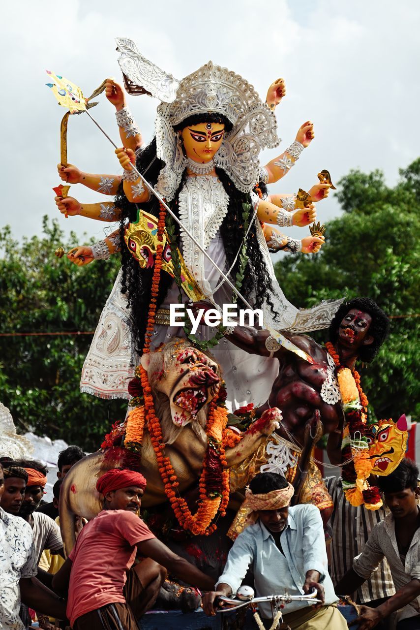 tradition, celebration, festival, arts culture and entertainment, event, carnival, group of people, men, clothing, nature, traditional clothing, day, performance, outdoors, adult, person, representation, tree, creativity, religion, sky