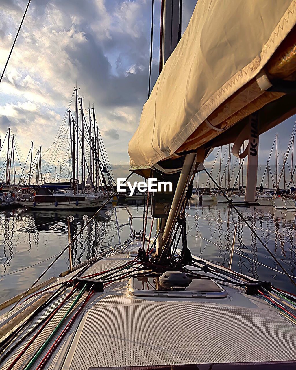 Boats moored at lake against sky