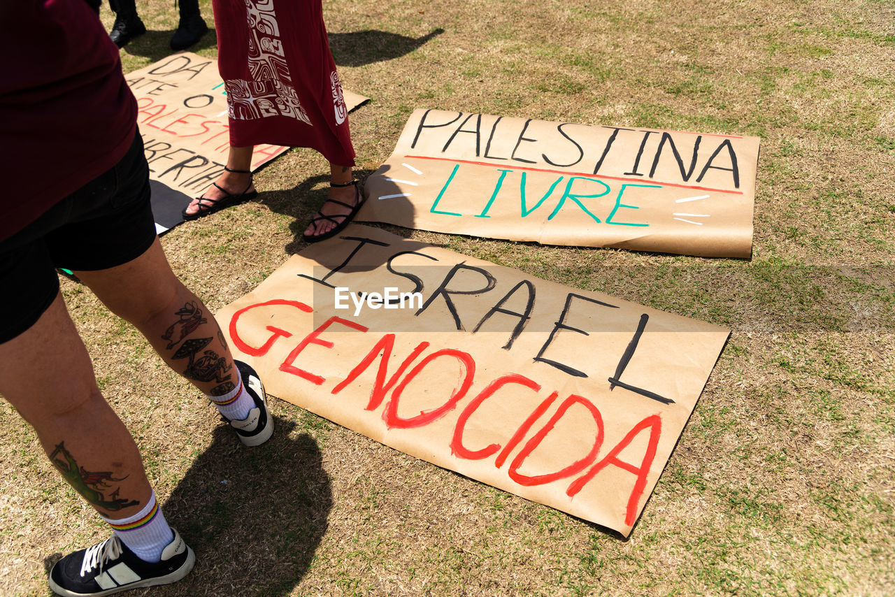 Posters are seen on the ground with words against the war in palestine during a protest 