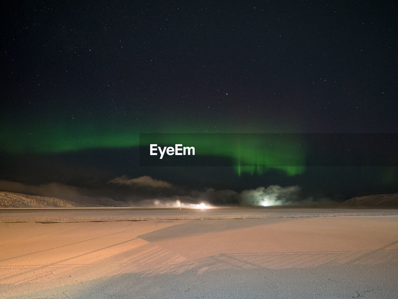 Scenic view of landscape against sky at night during winter