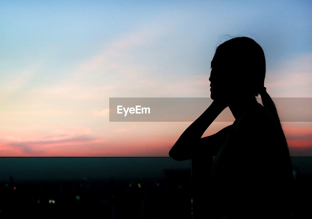 Side view of silhouette woman against sky during sunset