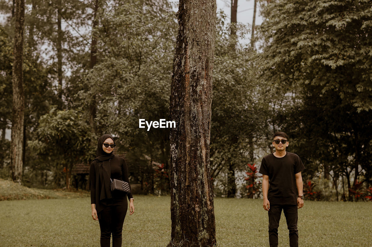 Full length of a man standing on tree trunk