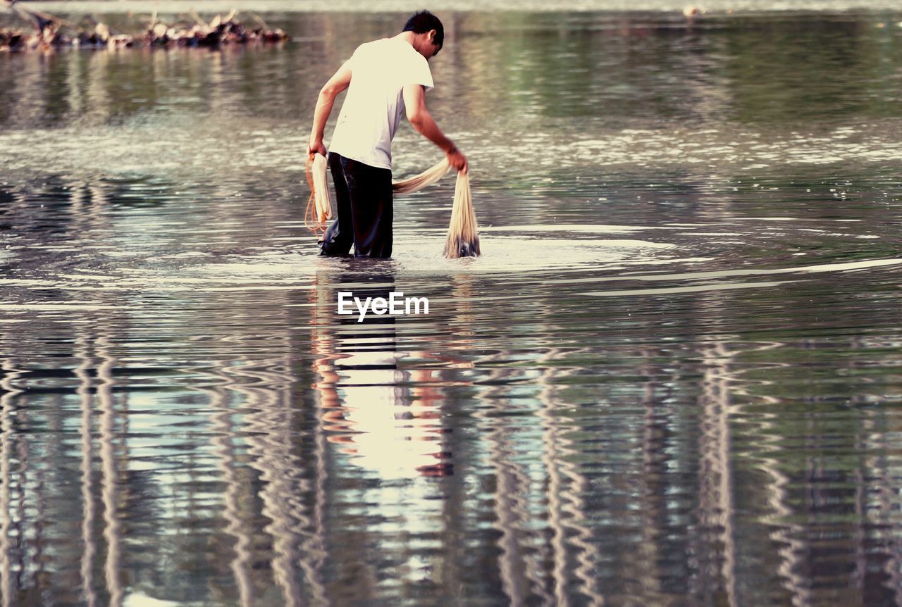 YOUNG WOMAN STANDING IN WATER