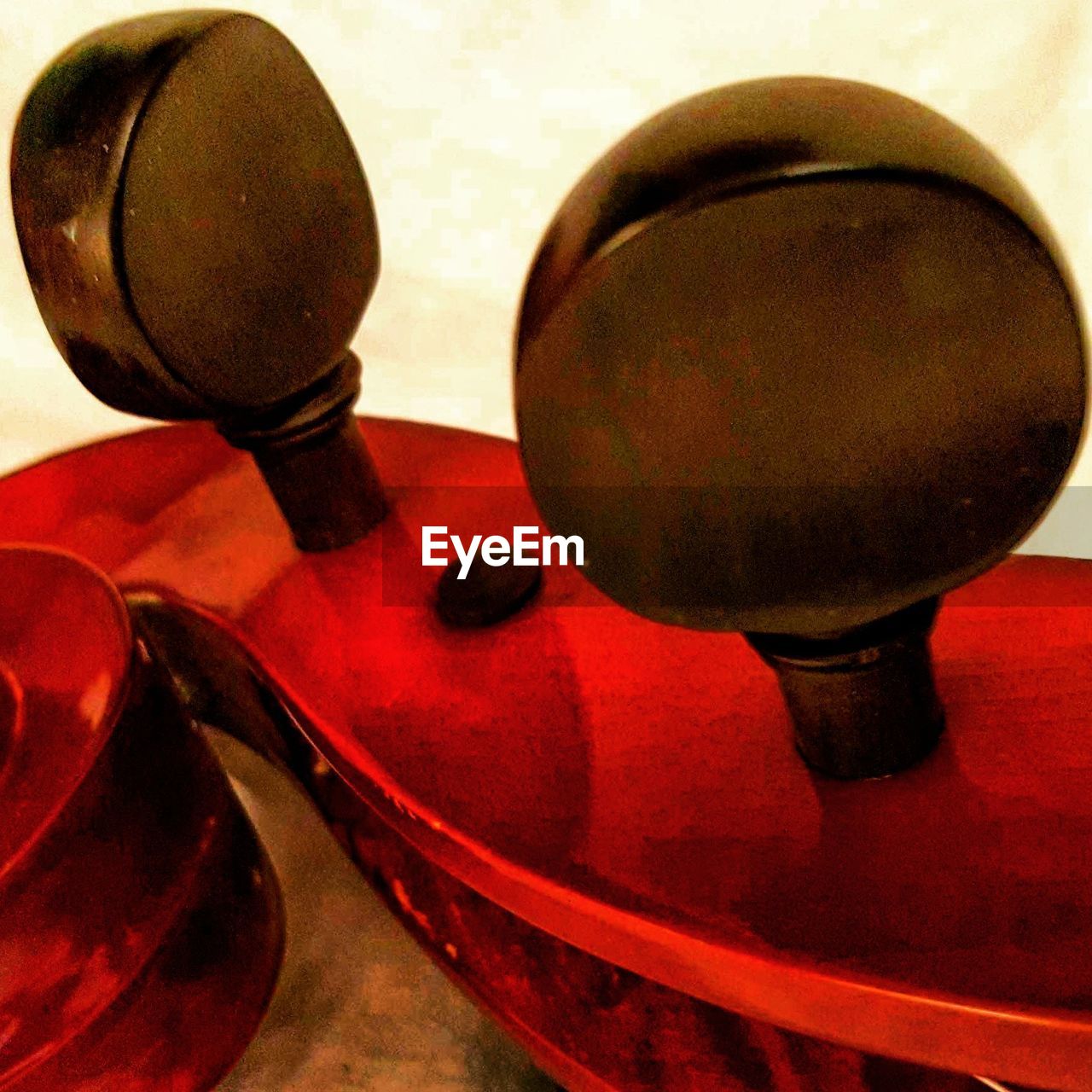 CLOSE-UP OF RED OBJECT ON TABLE