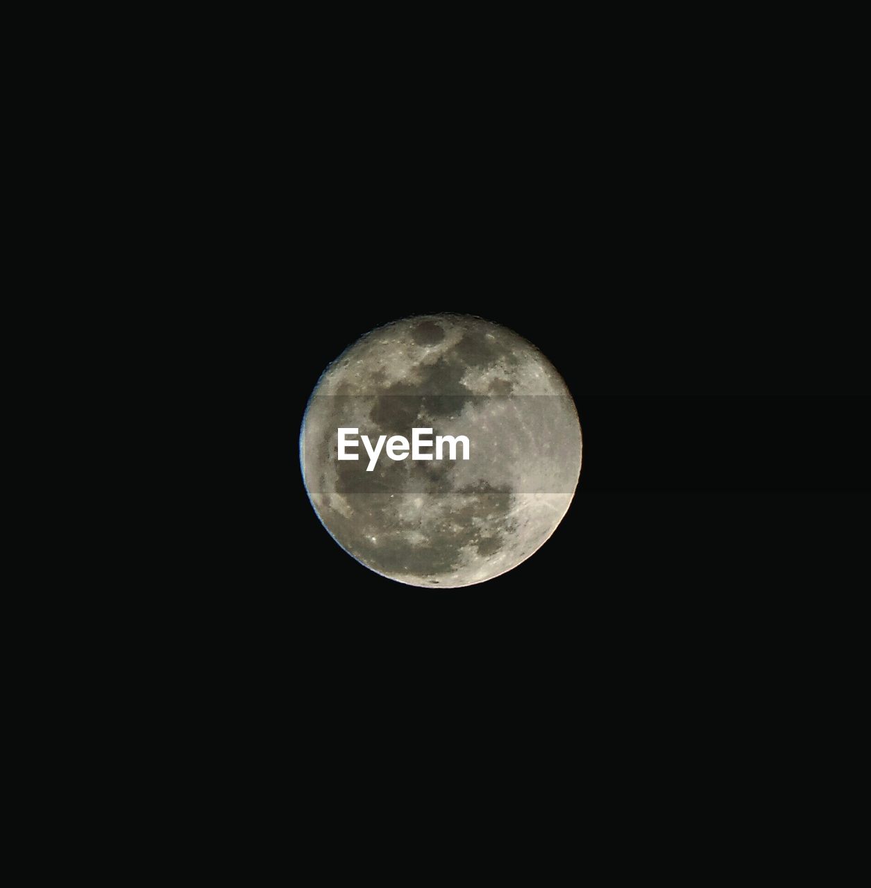 Low angle view of full moon in clear sky at night