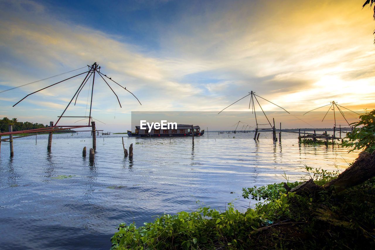 VIEW OF FISHING NET IN SEA AGAINST SKY