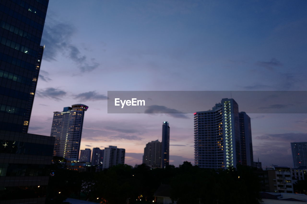 MODERN BUILDINGS AGAINST SKY AT DUSK