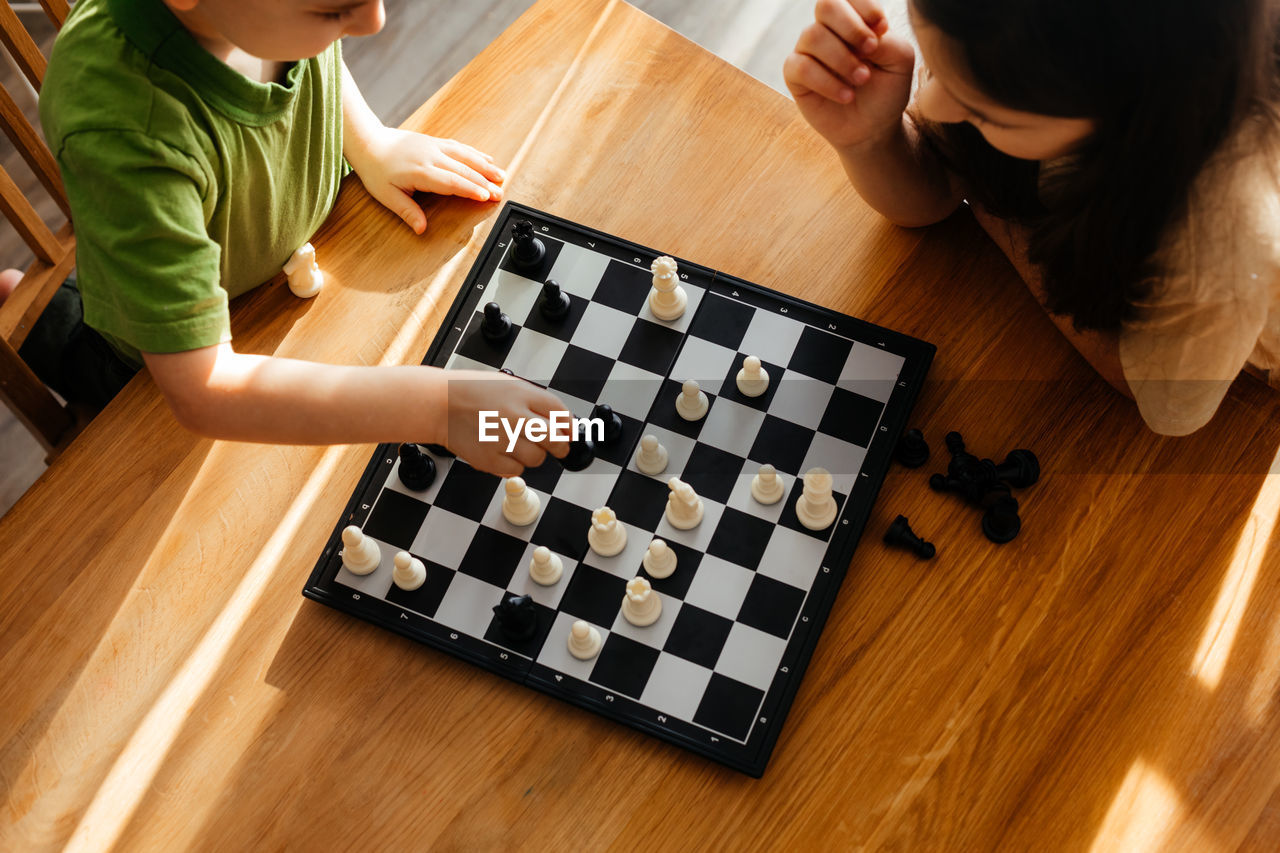 High angle view of baby playing on table at home