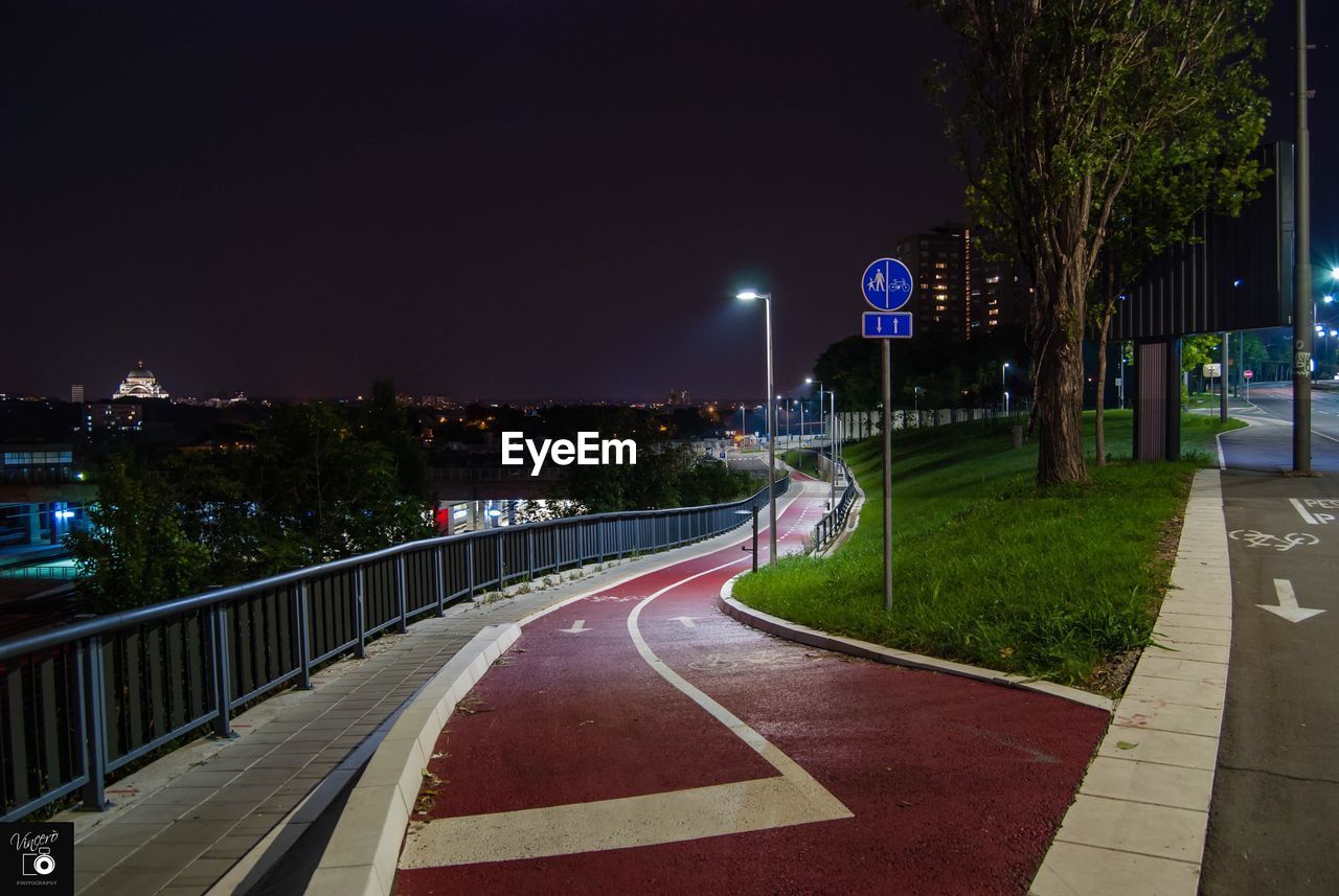 Empty road in city at night