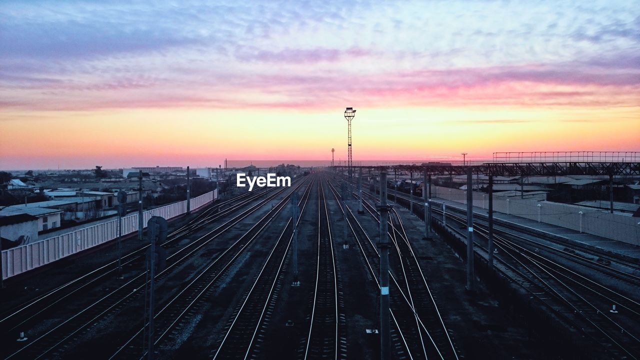 HIGH ANGLE VIEW OF RAILROAD TRACKS DURING SUNSET