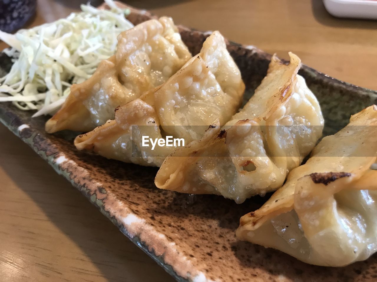 food and drink, food, asian food, freshness, dish, indoors, healthy eating, mandu, cuisine, dumpling, chinese food, wellbeing, table, no people, close-up, still life, wonton, chinese dumpling, focus on foreground, wood, serving size, japanese food, seafood, plate, meal