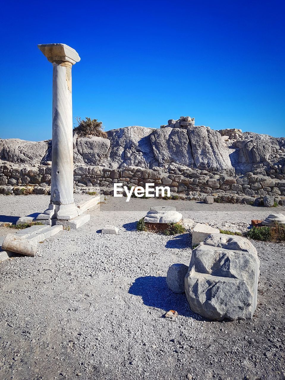 TEXT ON ROCK AGAINST BLUE SKY