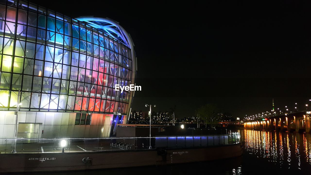 REFLECTION OF ILLUMINATED BUILDINGS IN WATER