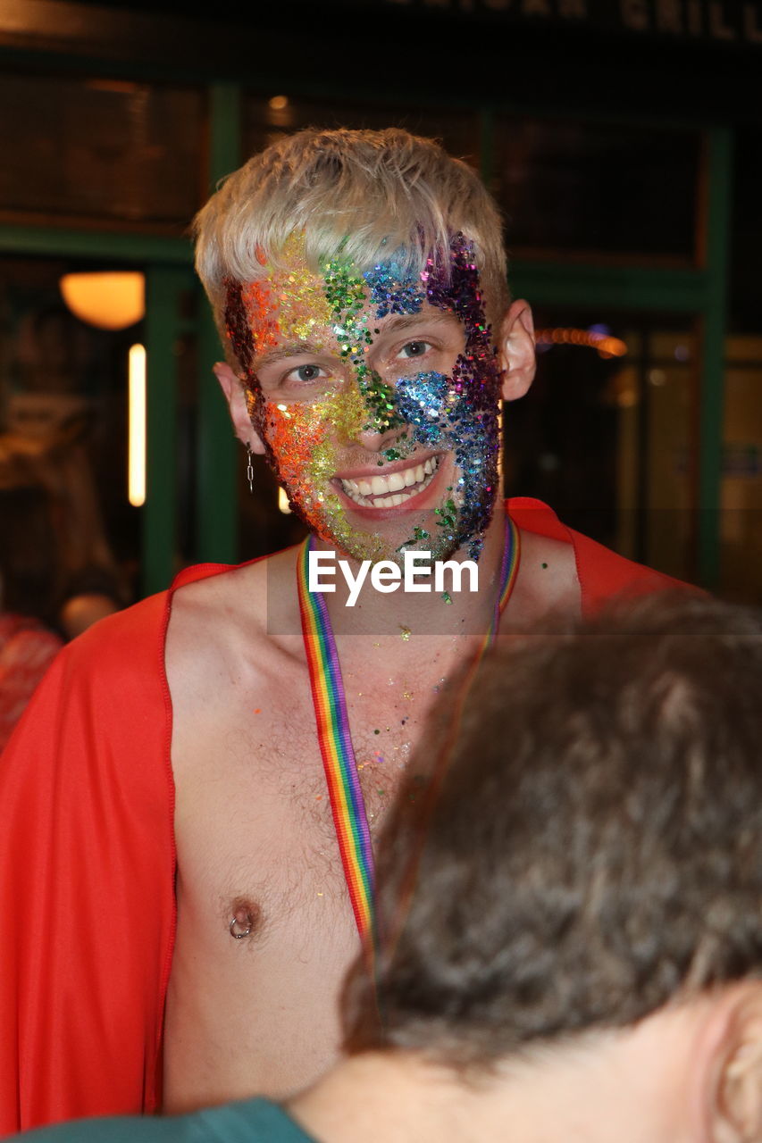 PORTRAIT OF MAN WITH MULTI COLORED FACE