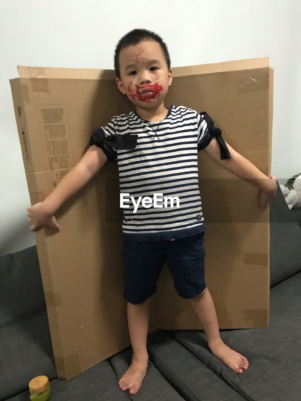 Portrait of boy with messy face standing at home