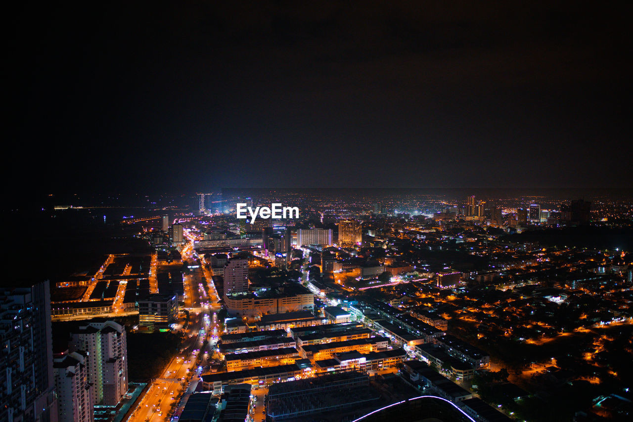 High angle view of illuminated buildings in city at night