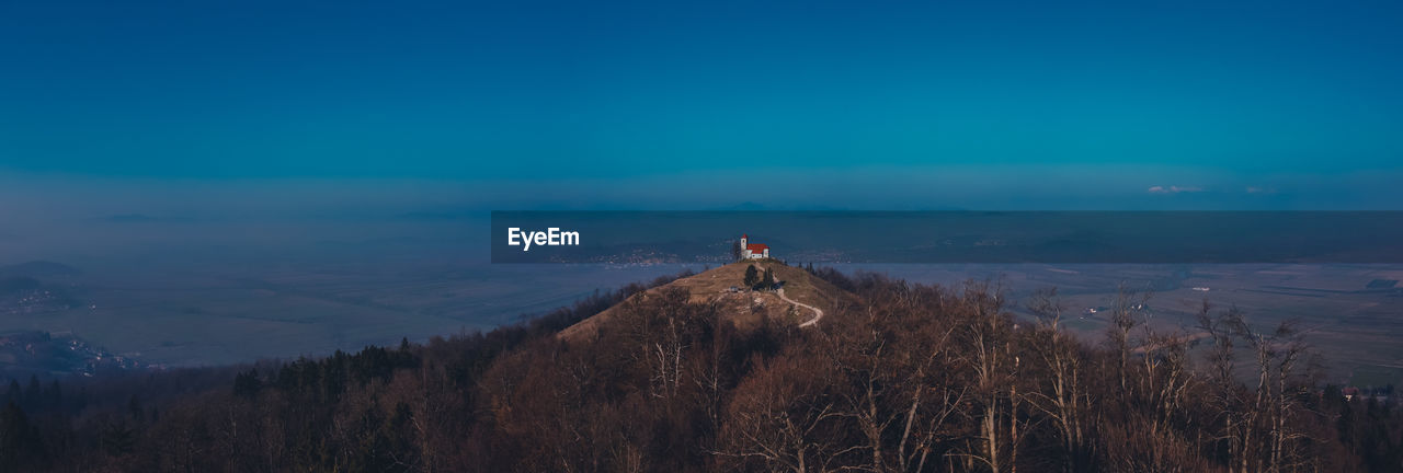 View of house on hill against landscape