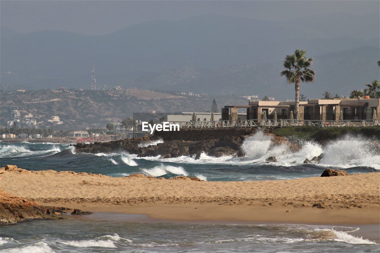 SCENIC VIEW OF SEA AGAINST BUILDINGS