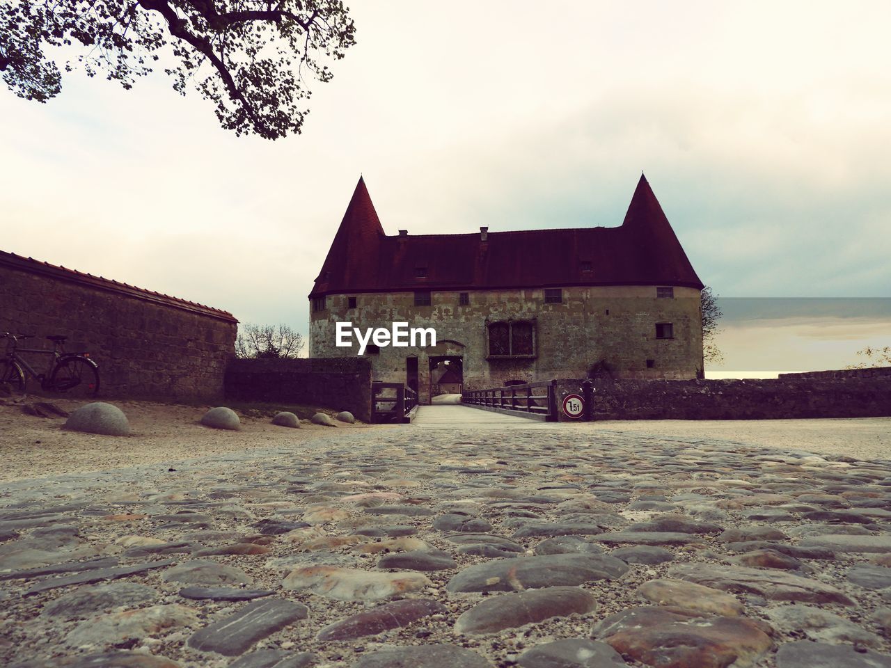 OLD HOUSES BY BUILDING AGAINST SKY