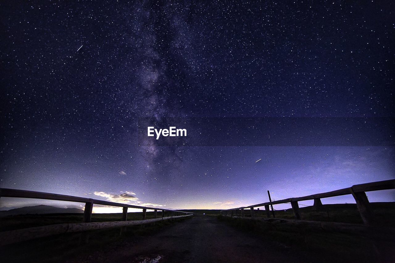 Road against sky at night