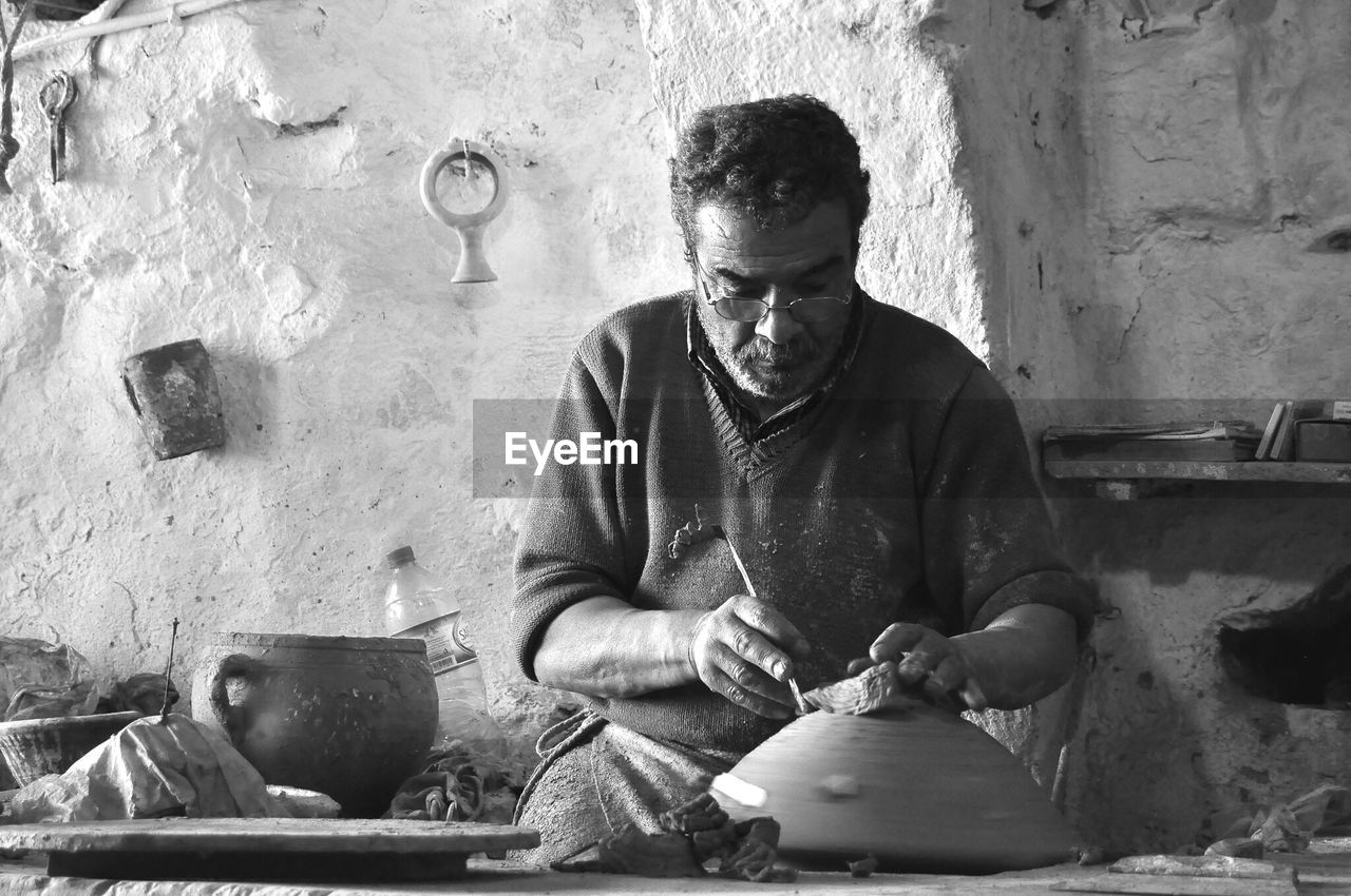 MAN WORKING IN TRADITIONAL CLOTHING