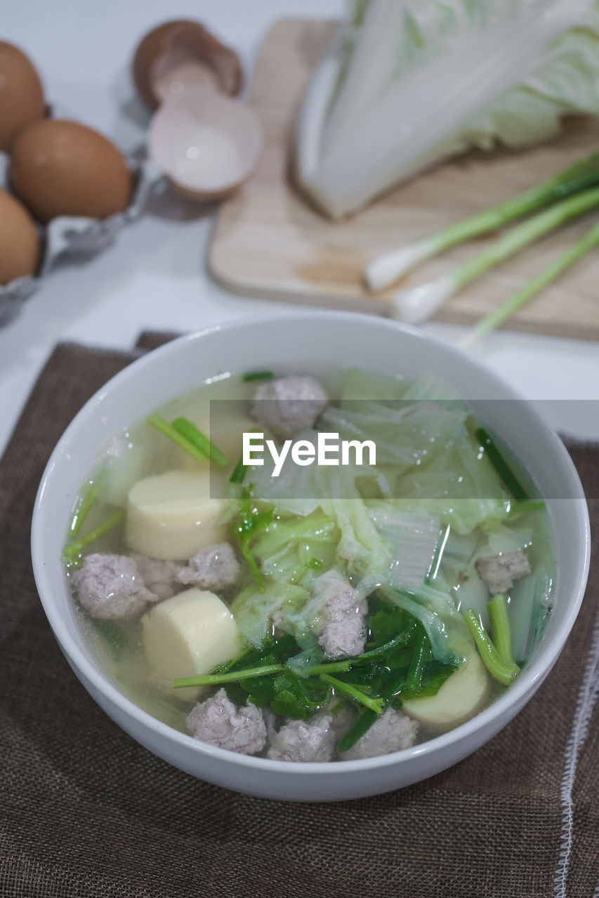 CLOSE-UP OF SOUP IN BOWL ON TABLE