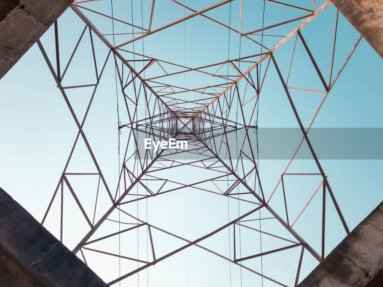 Low angle view of electricity pylon against clear sky