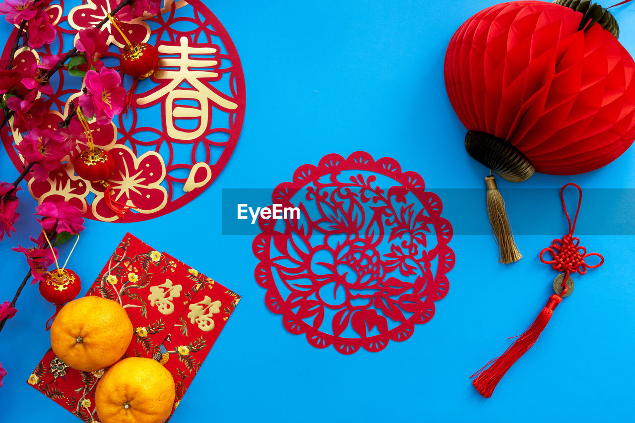 Chinese lunar new year decoration over blue background. flat lay concept with festive decoration.