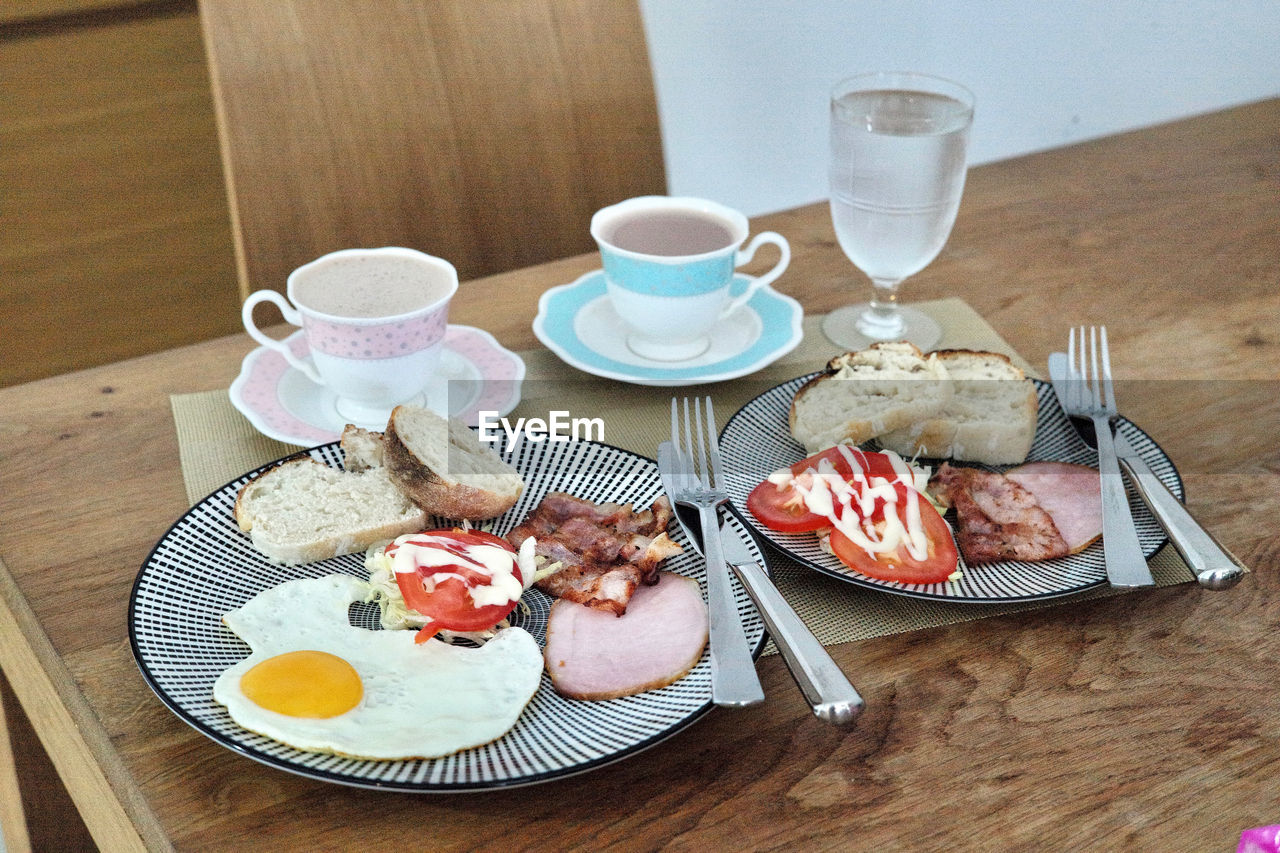 HIGH ANGLE VIEW OF BREAKFAST AND COFFEE SERVED ON TABLE