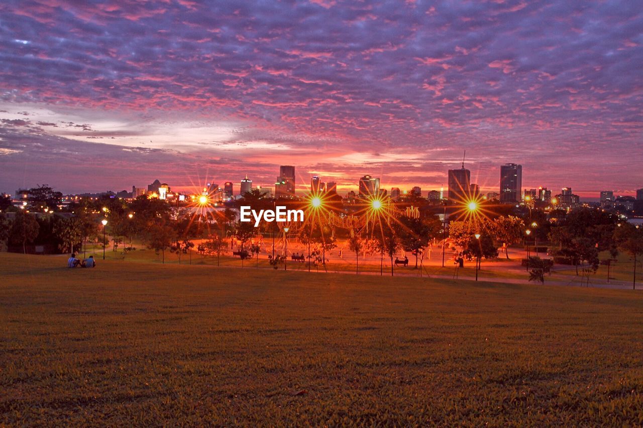 View of cityscape lit up at dusk