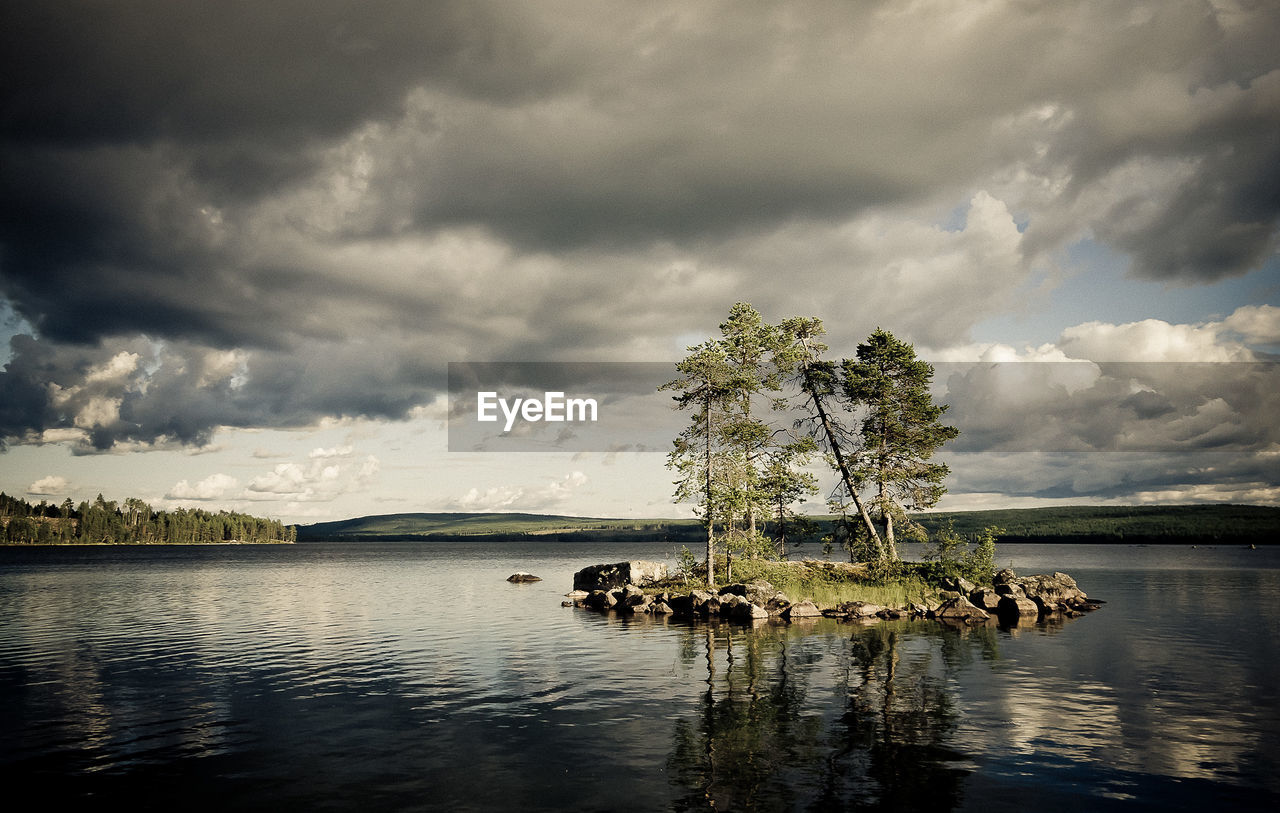 Scenic view of lake against cloudy sky