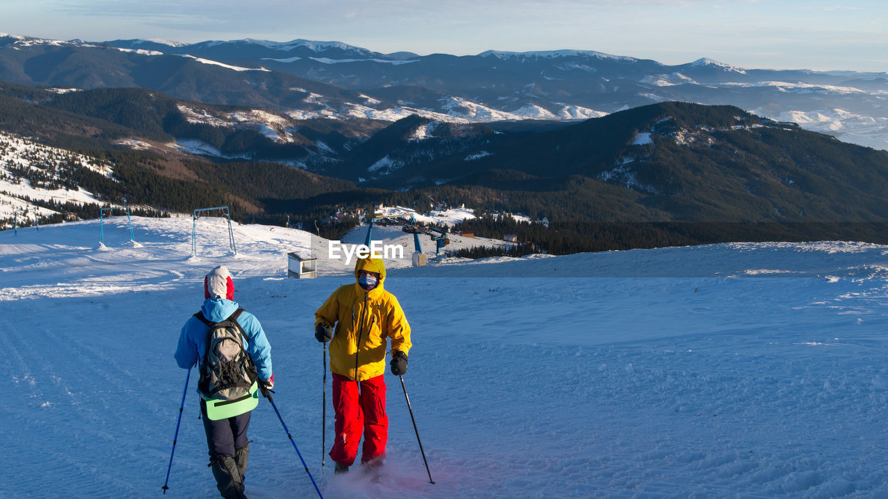 People skiing on snowcapped mountain