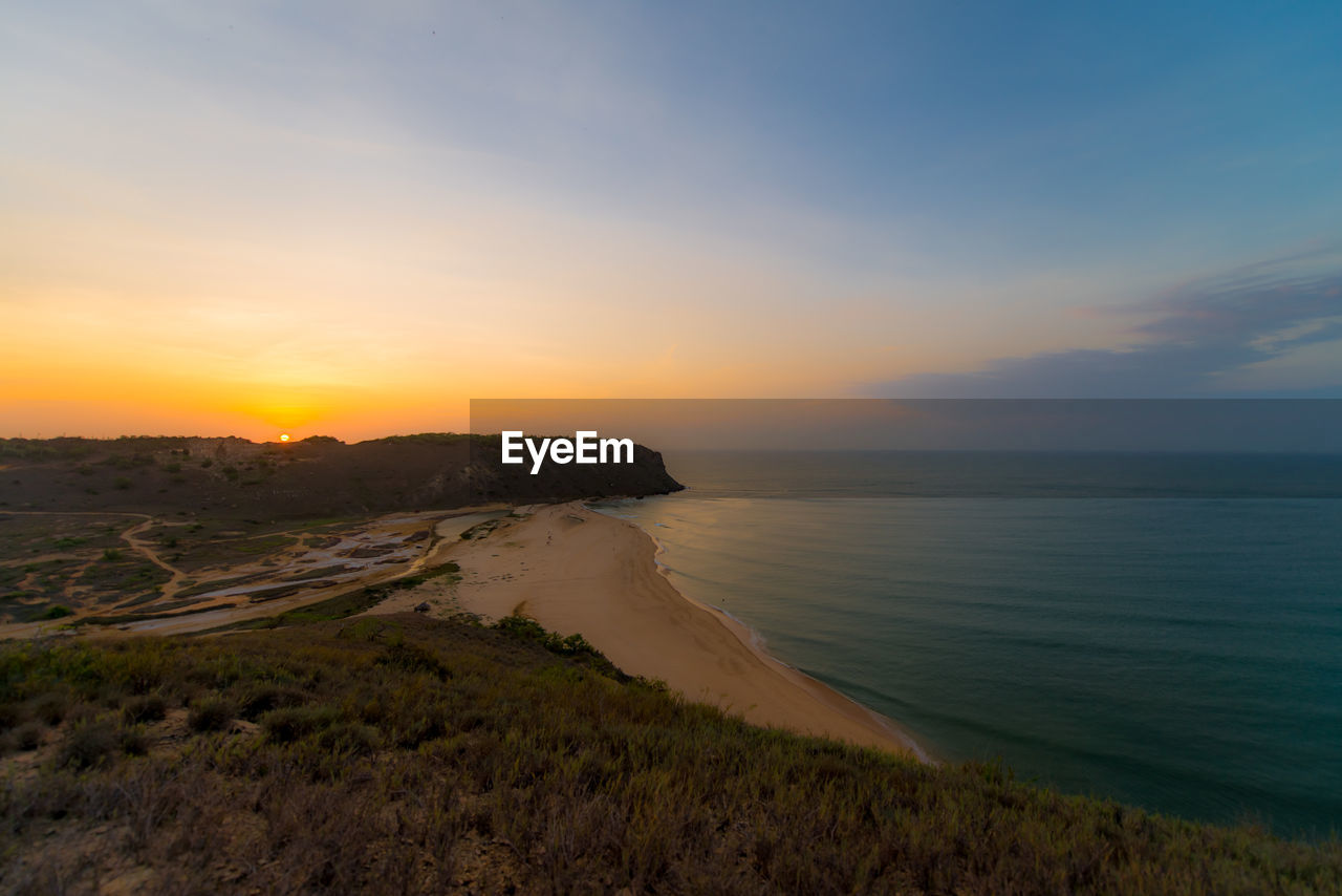 scenic view of sea against clear sky during sunset