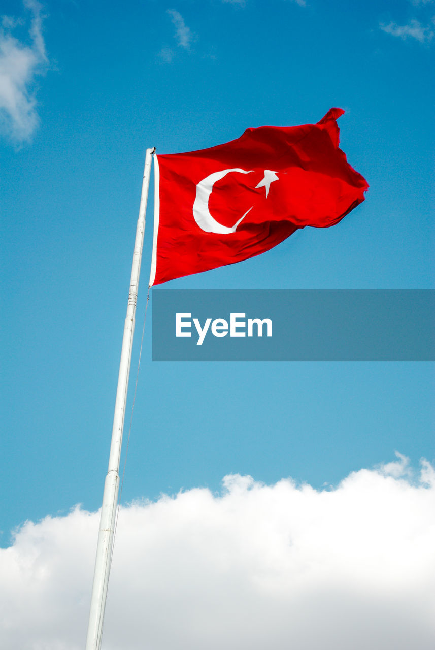 Low angle view of turkish flag against sky