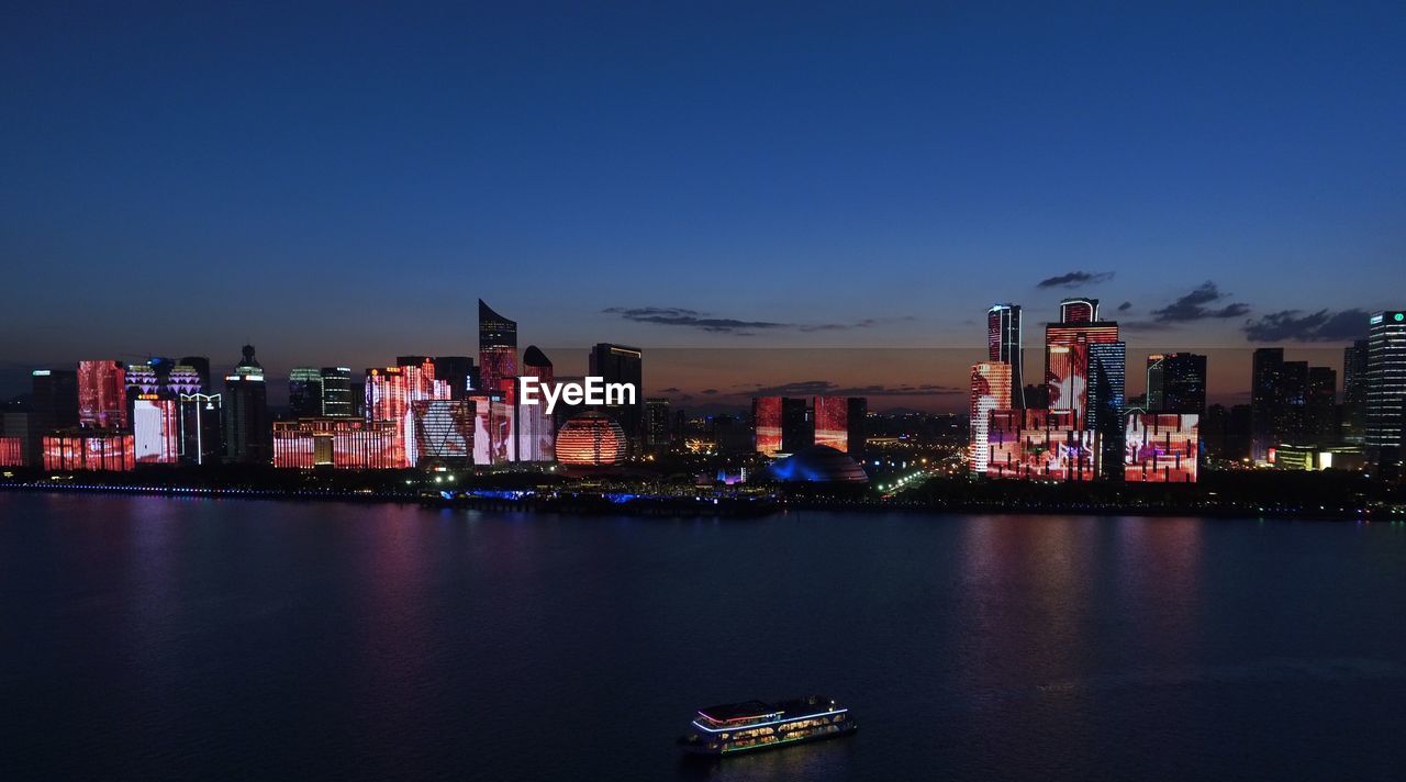 Illuminated modern buildings in city at night